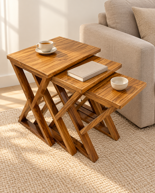 Three-Piece Wooden Nesting Table Set with Angled Legs on a cream studio background, showing the complete design.