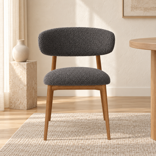 Upholstered Wooden Dining Chair in Charcoal Grey bouclé, shown in a lifestyle setting.