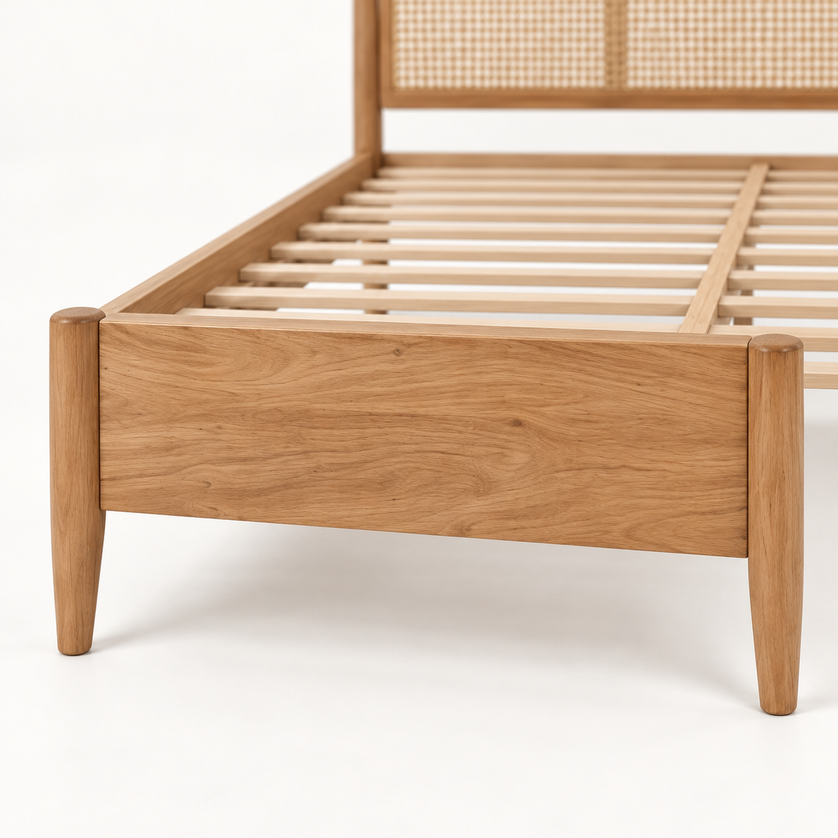 Light Wood Cane Bed in teak wood — close-up of footboard