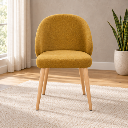 Mustard Upholstered Dining Chair, front view in a styled lifestyle setting.