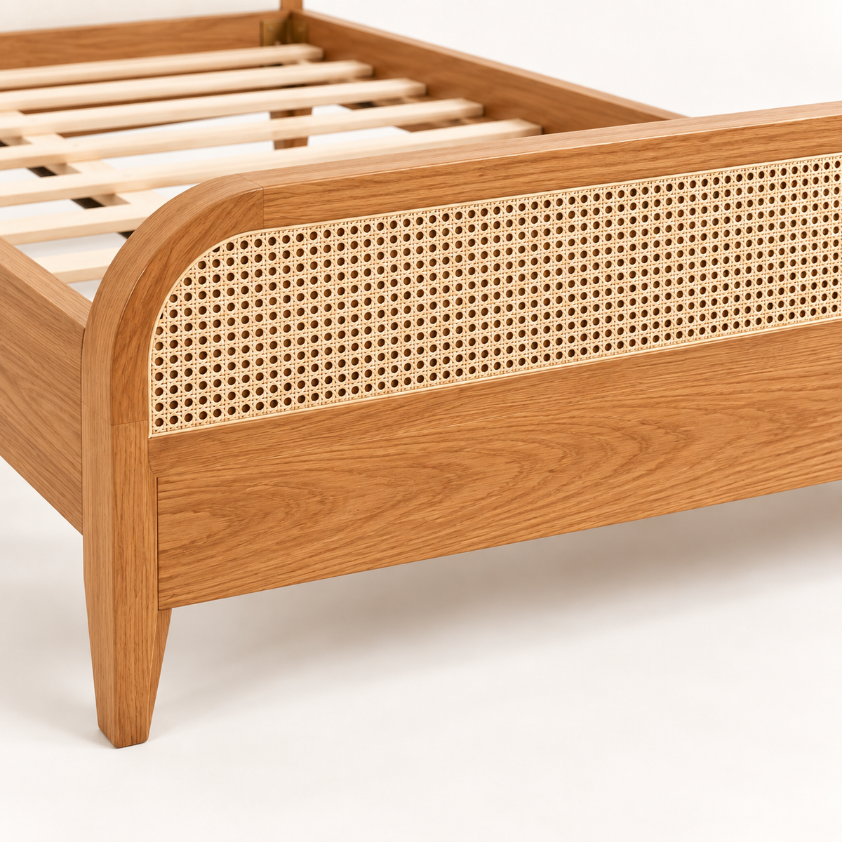 Rounded Cane and Leatherette Bed in teak wood — close-up of footboard