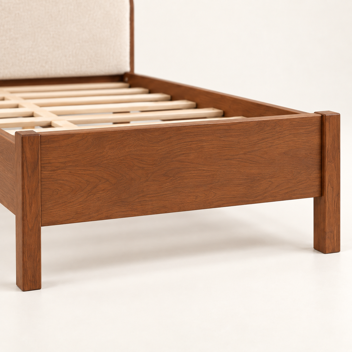 Rounded Leatherette Wooden Bed in teak wood — close-up of footboard