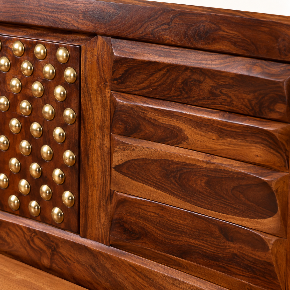 Close-up of brass studs and dark walnut finish on Sheesham wood bed