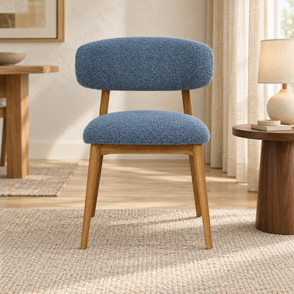 Upholstered Wooden Dining Chair in Dusty Blue bouclé, shown in a lifestyle setting.