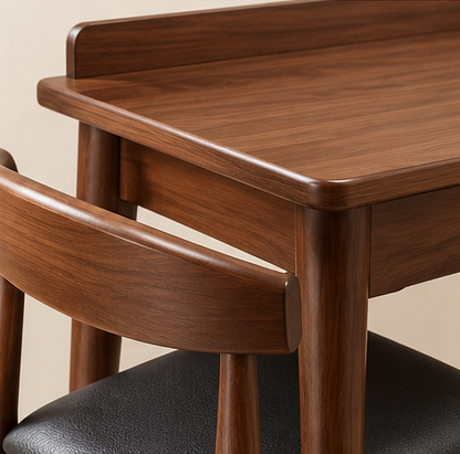 Detail view of walnut finish veneer tabletop rounded edges and matching cushioned chair